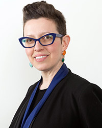 a headshot of a woman wearing glasses 