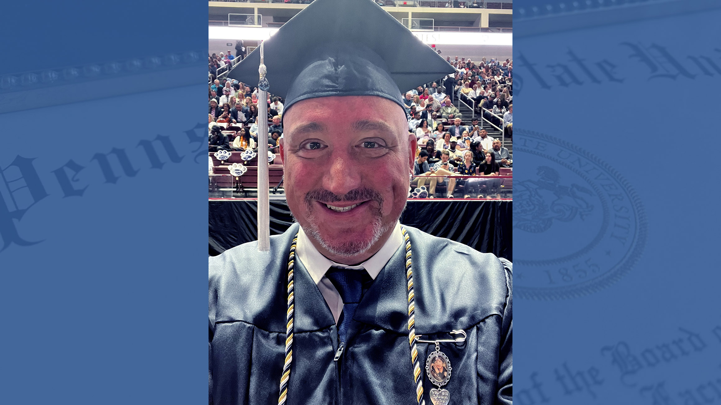 a headshot of a man wearing a graduation gap with a faded diploma in the background