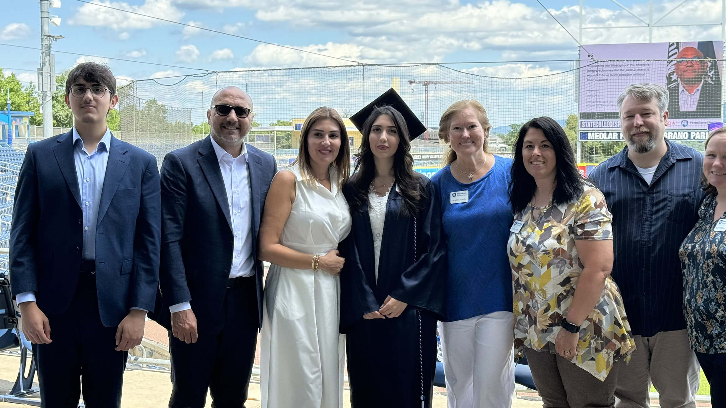 A group of people pose for a photo with a graduate
