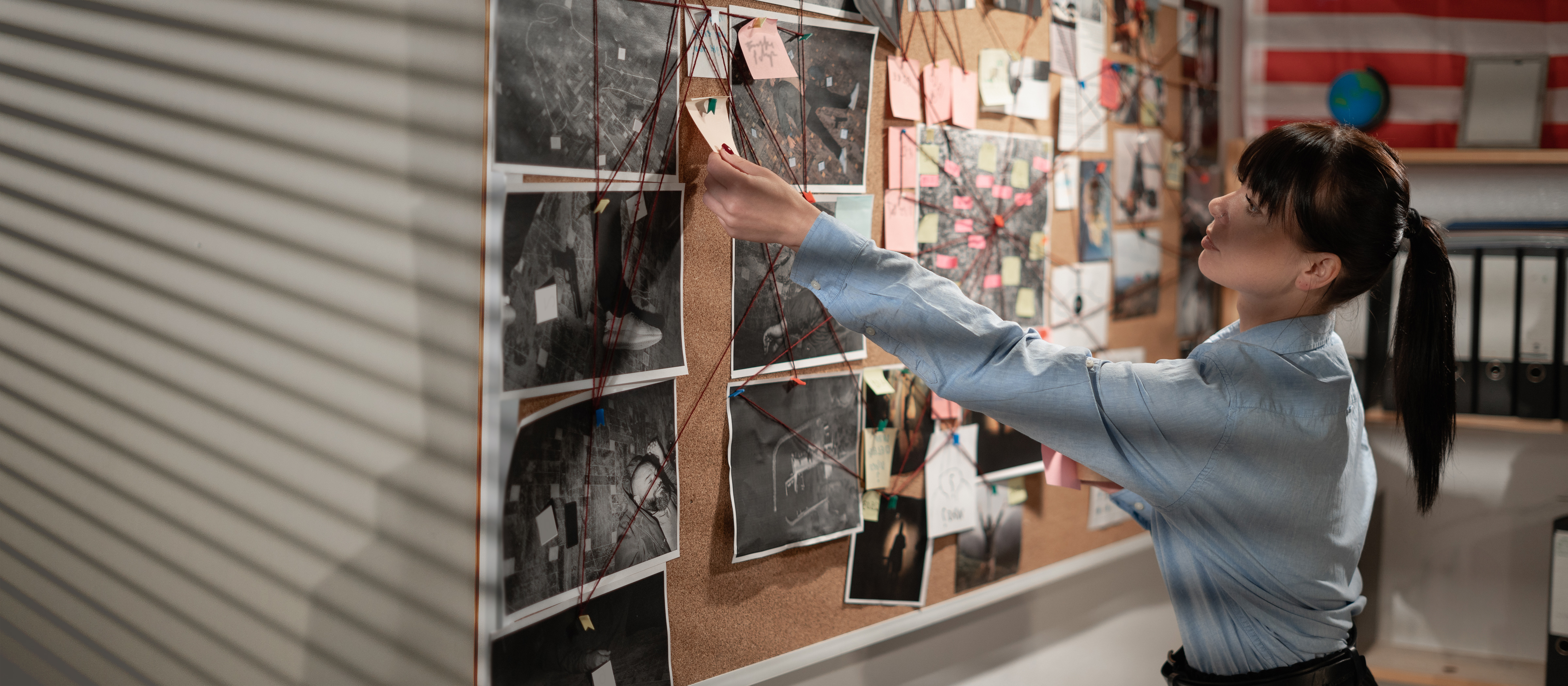 criminology professional looking at a bulletin board 