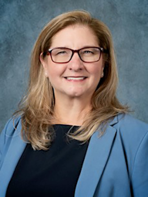 A woman wearing a blue blazer.