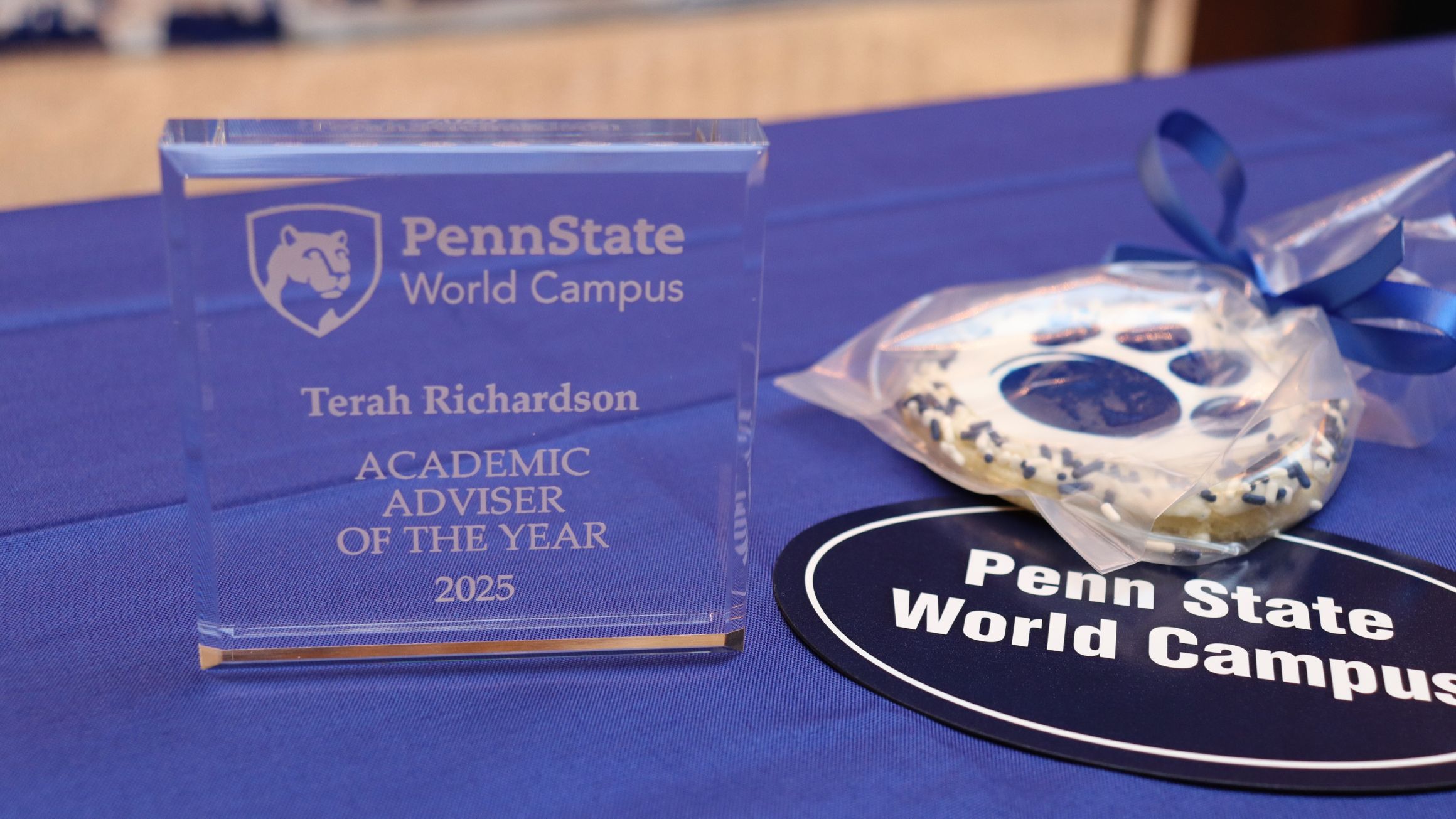 a plaque and a cookie are shown with a Penn State world campus sticker