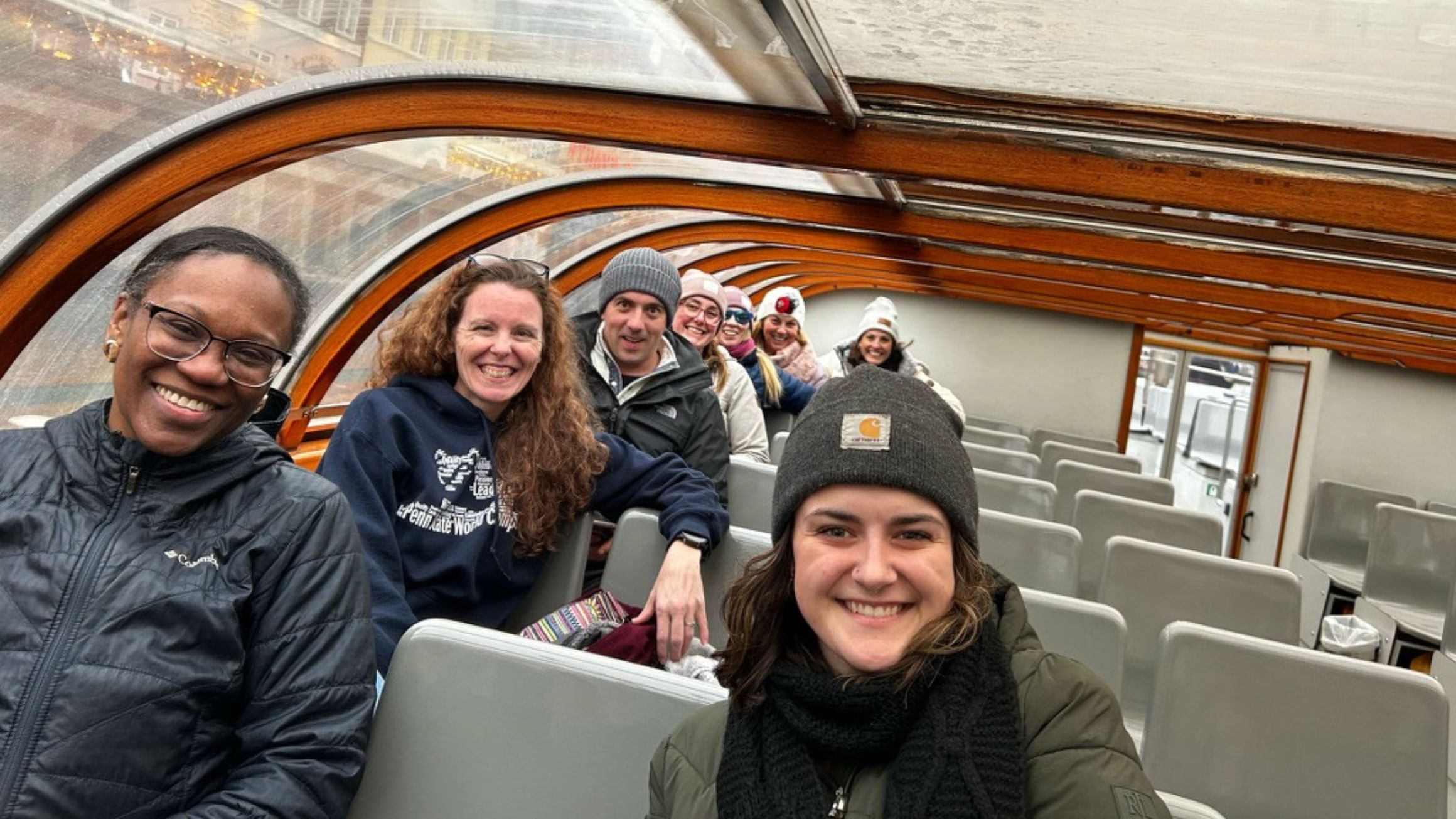 a woman in a boat smiles with three people in the background
