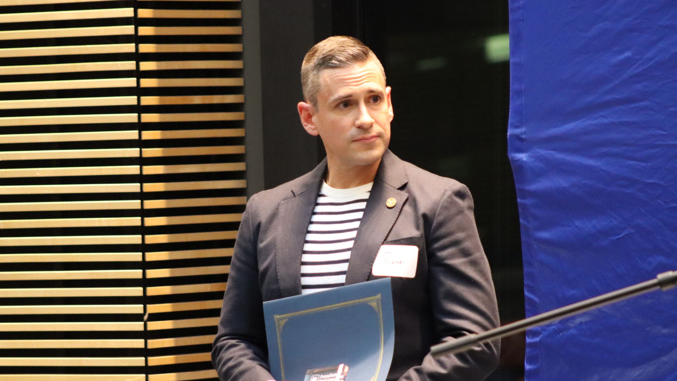 a man is shown holding an award
