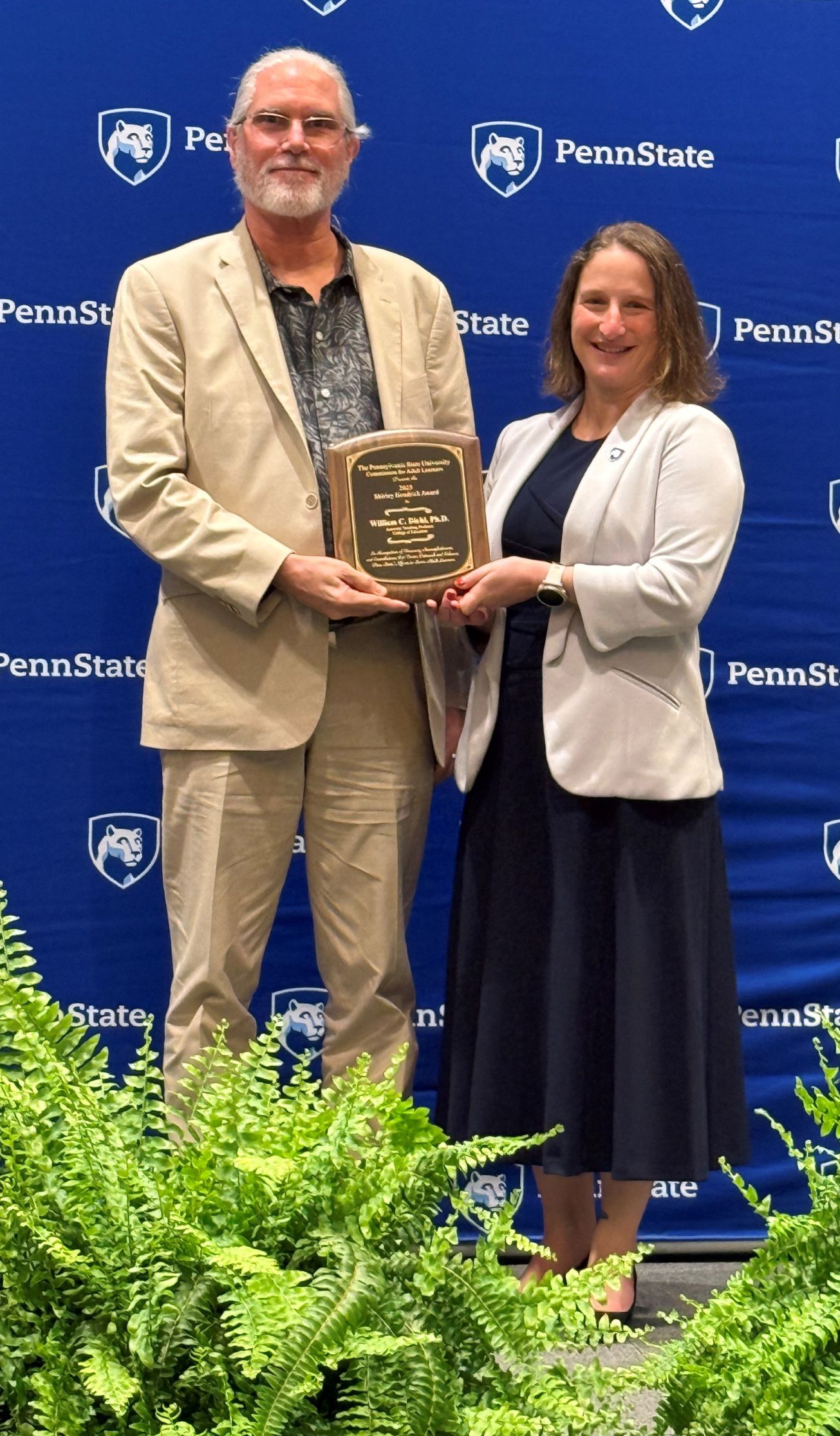 william diehl holds an award while standing next to the provost