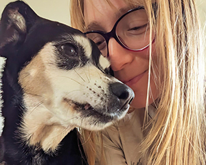 A woman and a black and tan dog.