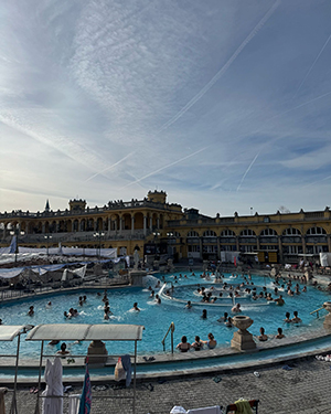 A large swimming pool in a town square area.