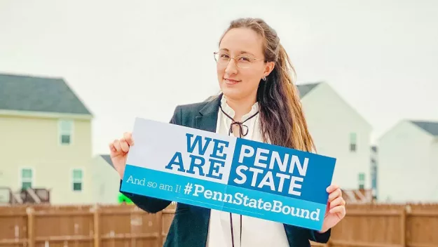A new student holding a sign that reads, We Are Penn State and #PennStateBound