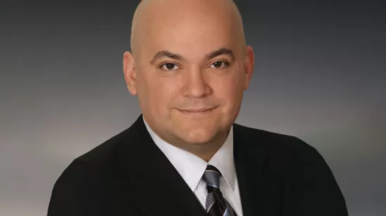 Headshot of Mike Russo in a black suit.