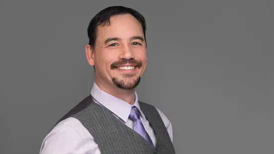 Headshot of Steven Shelley in a gray vest and button down.