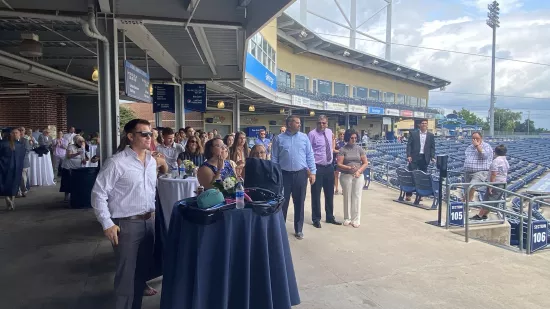 This photo shows attendees standing at the Penn State World Campus Summer 2021 Graduation Celebration at Medlar Field.