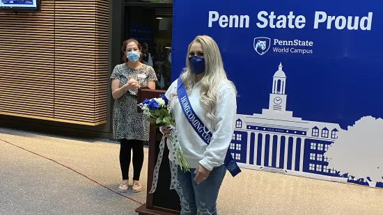 Ariel Hinojos stands wearing a homecoming sash