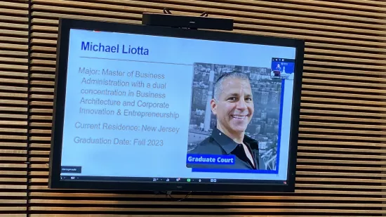 A presentation slide shows Michael Liotta