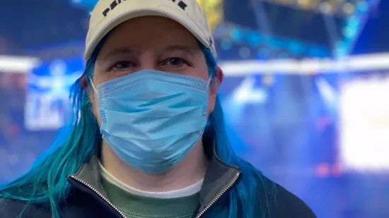 A student wearing a blue masks inside the Bryce Jordan Center for THON 2022