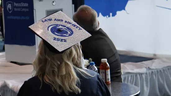 A graduate's cap reads "Law and society 2022"