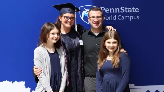 Ayshia Sigler, her husband and two daughters pose for a photo