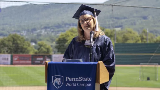 A graduate speaks at a podium.