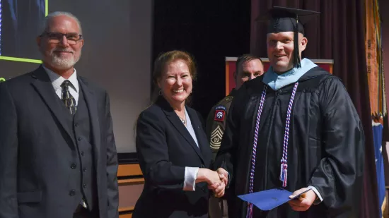 Sergeant Major Aaron Beckman shakes hands with Renata Engel