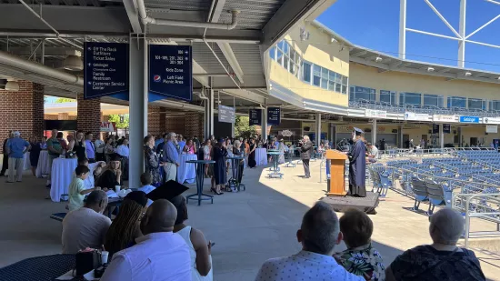 The crowd at the Summer 2022 Penn State World Campus Graduation Celebration listens to a speaker at a podium