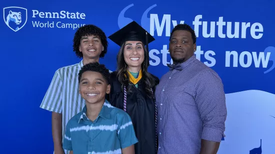 Edith Brooks poses with her family behind a "My Future Starts Now" backdrop