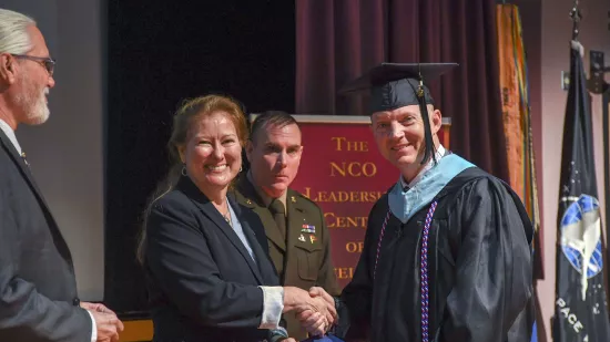 Jason Duncan shakes hands with Renata Engel