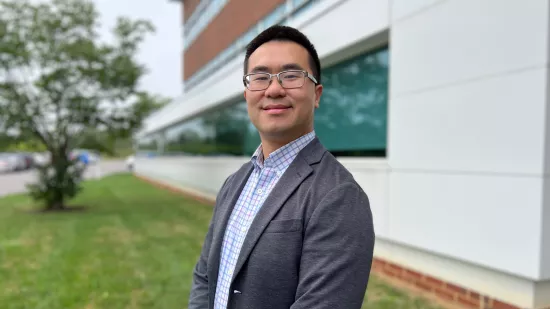 Julian Fung stands in front of a building at Penn State