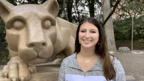 Marra Baker stands next to the Nittany Lion shrine