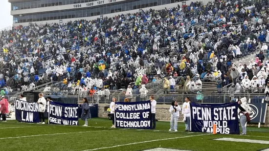 Students holding their campuses' flags for Dickinson Law, Penn State Great Valley, Pennsylvania College of Technology, and Penn State World Campus.