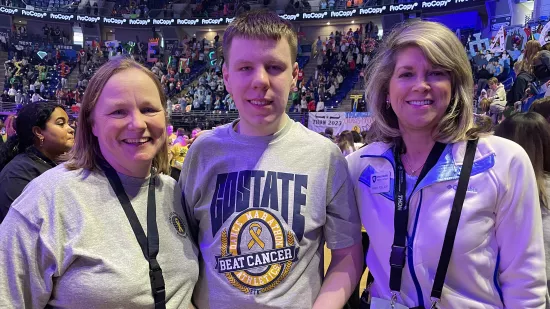 Three people pose for a photo at THON.