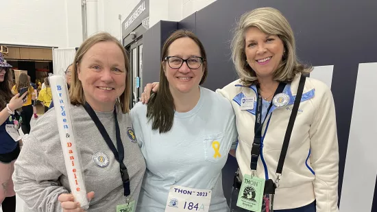 Three people pose for a photo at THON.