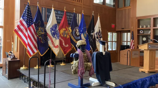 A series of flags are posted on a stage.