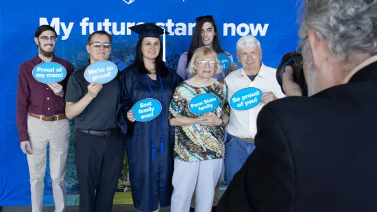 A group of people pose with a graduate for a photo.