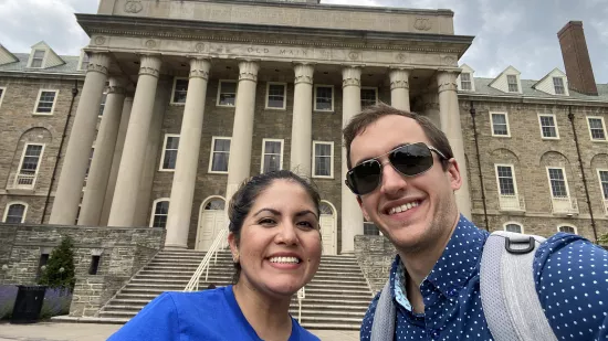 Jackie Salan and Daniel Serfass take a selfie with Old Main in the background
