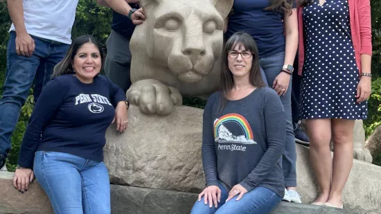 Members of the student advisory board and student government association pose around the Nittany Lion Shrine.