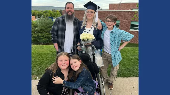 A group of people pose with a graduate for a photo.