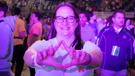 A woman makes a "diamond" with her fingers.