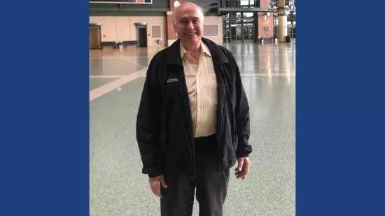 A man stands in a lobby area.