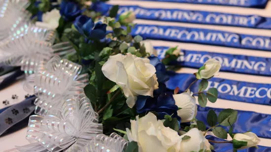 Blue and white flowers and a blue sash.