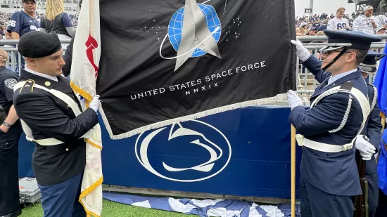 Two cadets from the space force hold the U.S. Space Force banner