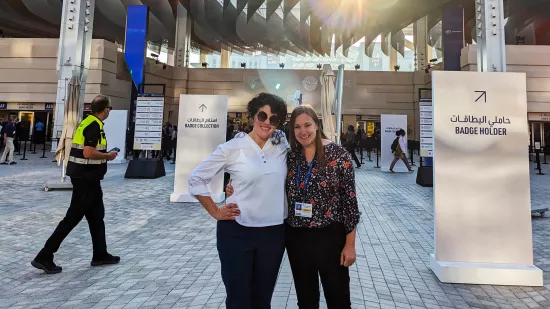 Olivia McMahon and Brandi Robinson pose for a photo outside the entrance