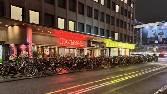 bicycles on a sidewalk in the dark in a city