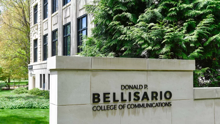 A sign on stone wall shows the name Donald P. Bellisario College of Communications
