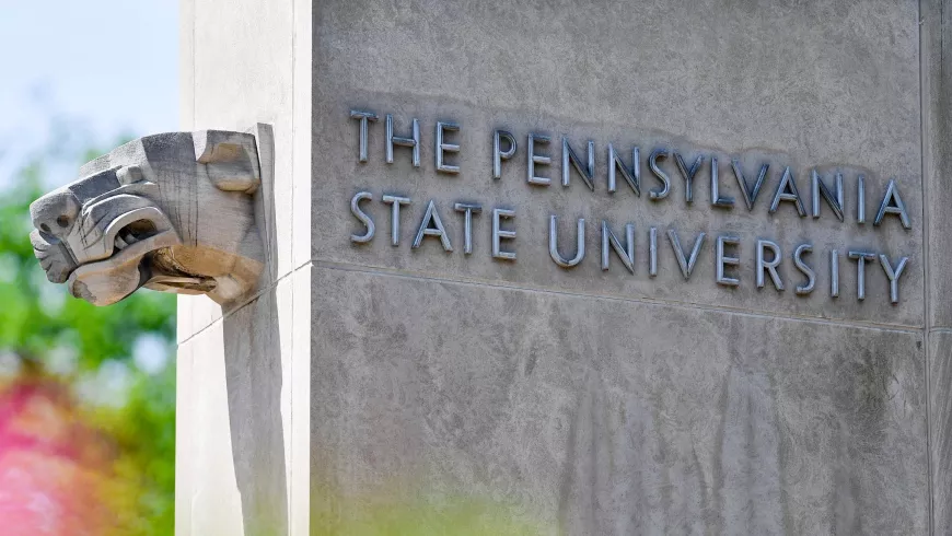 A concrete wall says "The Pennsylvania State University"