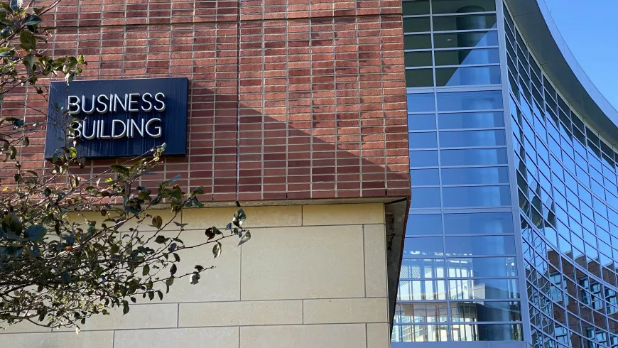 The Business Building sign on the brick exterior of the building.