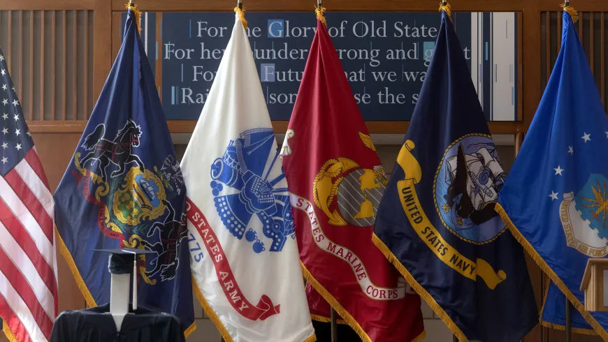 Flags from the U.S. and the service academies are shown