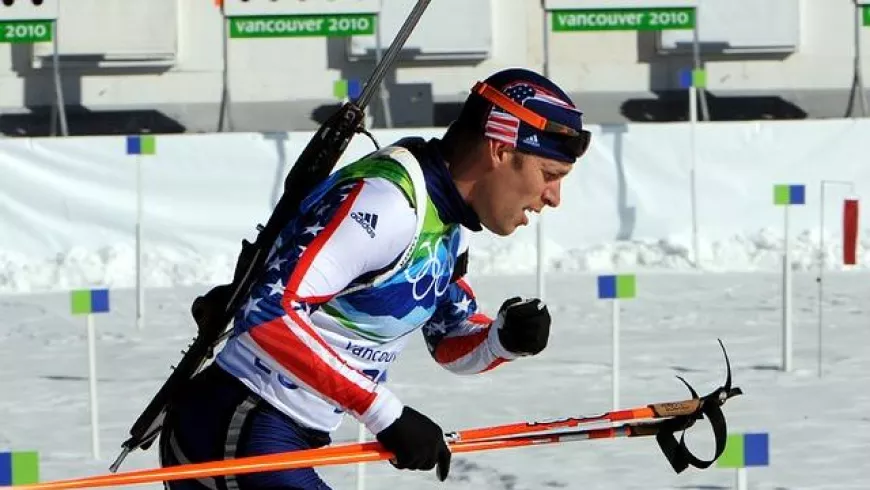 man competing in biathalon in snow