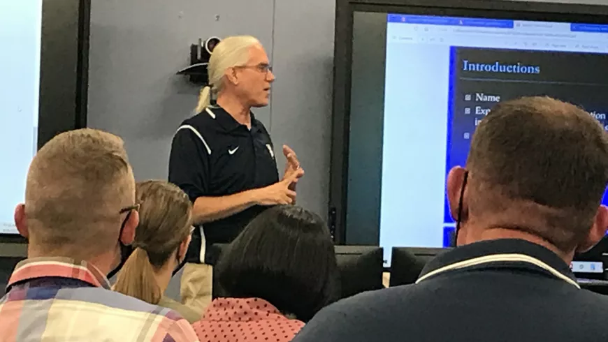William Diehl speaking in front of a classroom