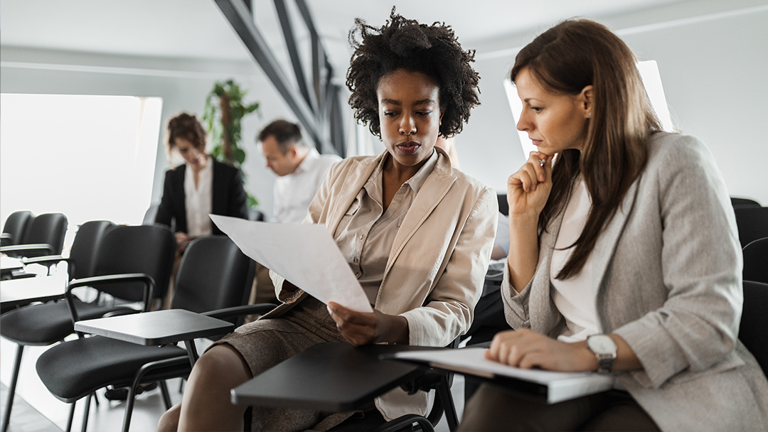 Two women reviewing documents together