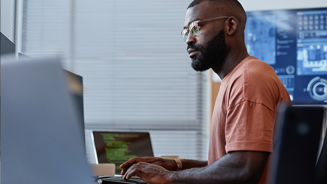 A software engineer coding at a computer